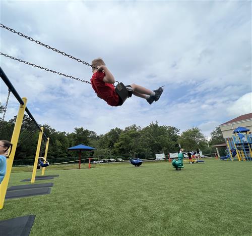 boy on swing on playground